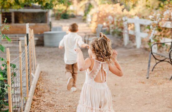 Family photography session at Agritopia Farm in Gilbert, AZ. Capturing joyful moments with a family, highlighting the beauty of the outdoor setting. Gilbert family photographer captures candid moments of parents and children, creating lasting memories in the vibrant, picturesque atmosphere of Agritopia